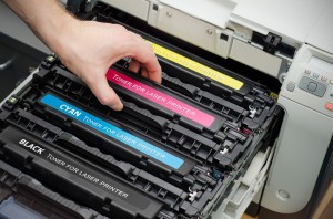 hand on toner cartridge