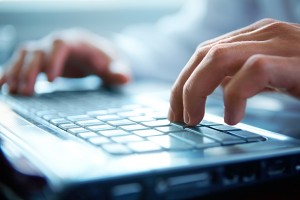 hands typing on keyboard